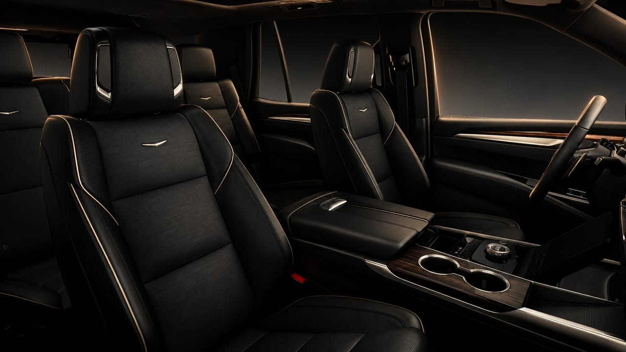 Premium black leather front seats with contrast stitching — luxury black SUV interior